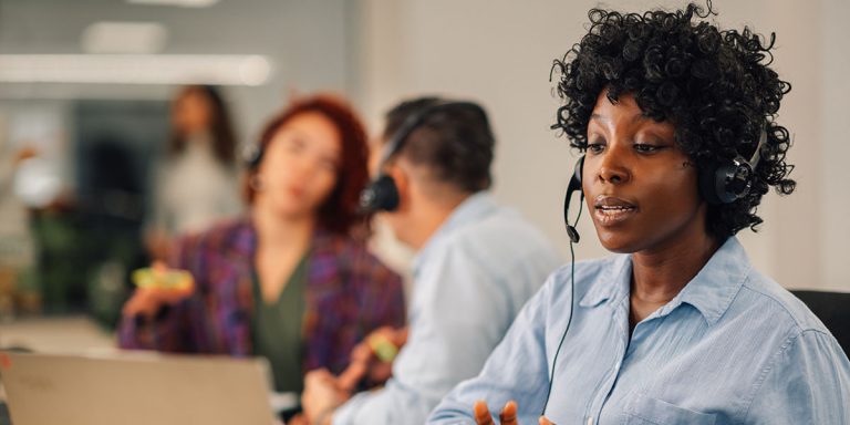 woman-answering-call-in-contact-centre